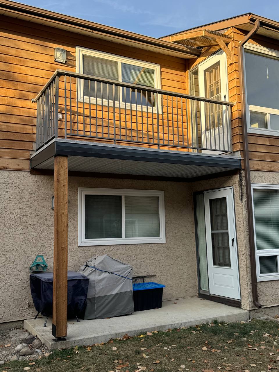 Modern composite deck with metal railing attached to residential home upper level